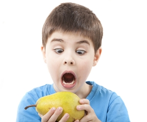 Kid holding pear